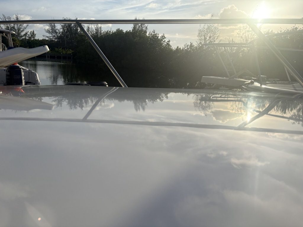 Sunlight reflecting across a white boat surface